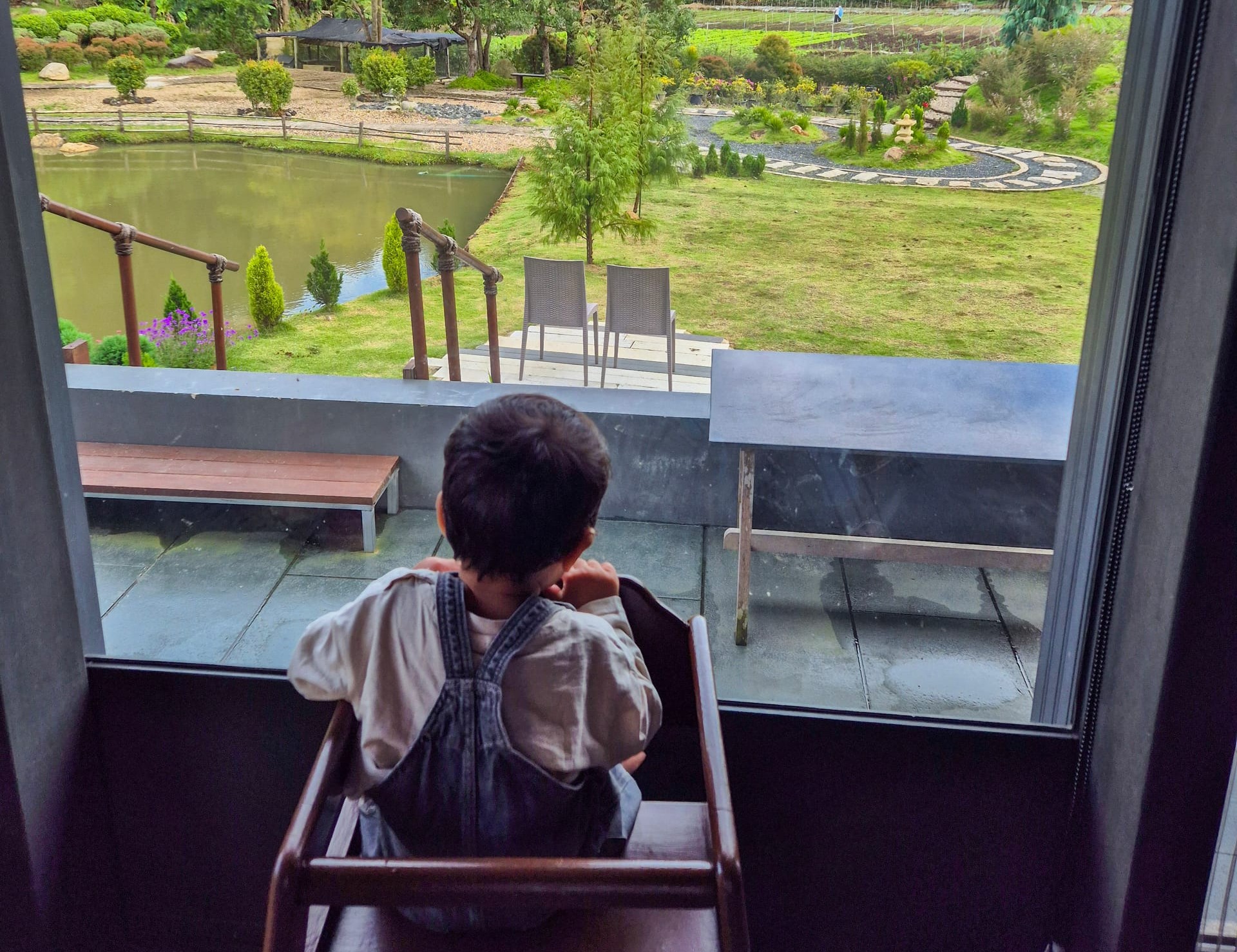 Toddler looking out at mountain views from Onsen @ Moncham